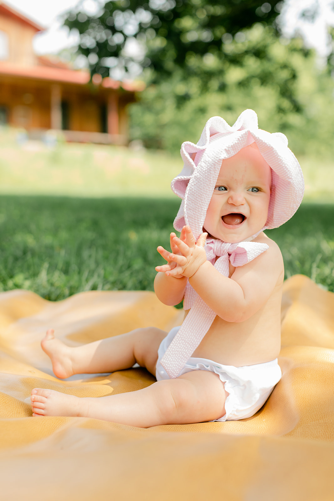 baby girl with pink bonnet 