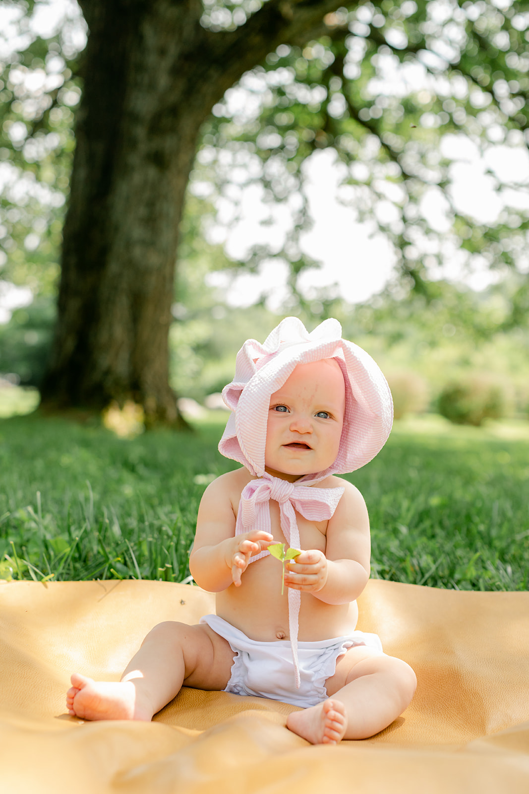 baby girl with pink bonnet 