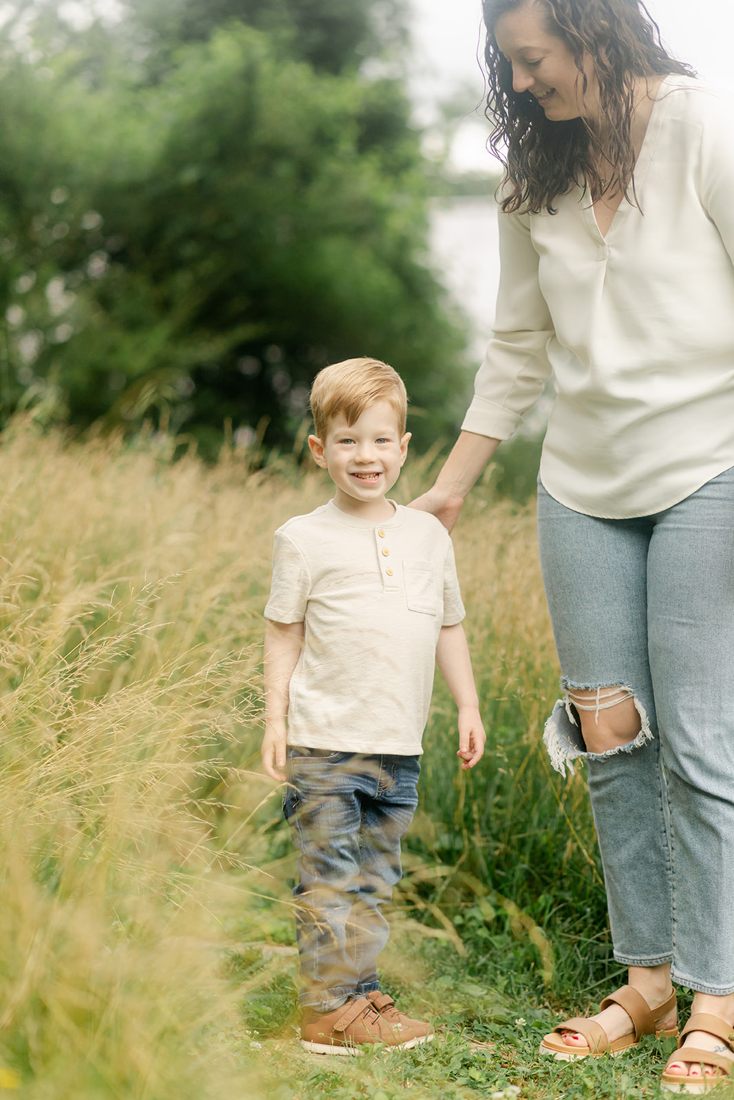 mama and little boy in tall grass