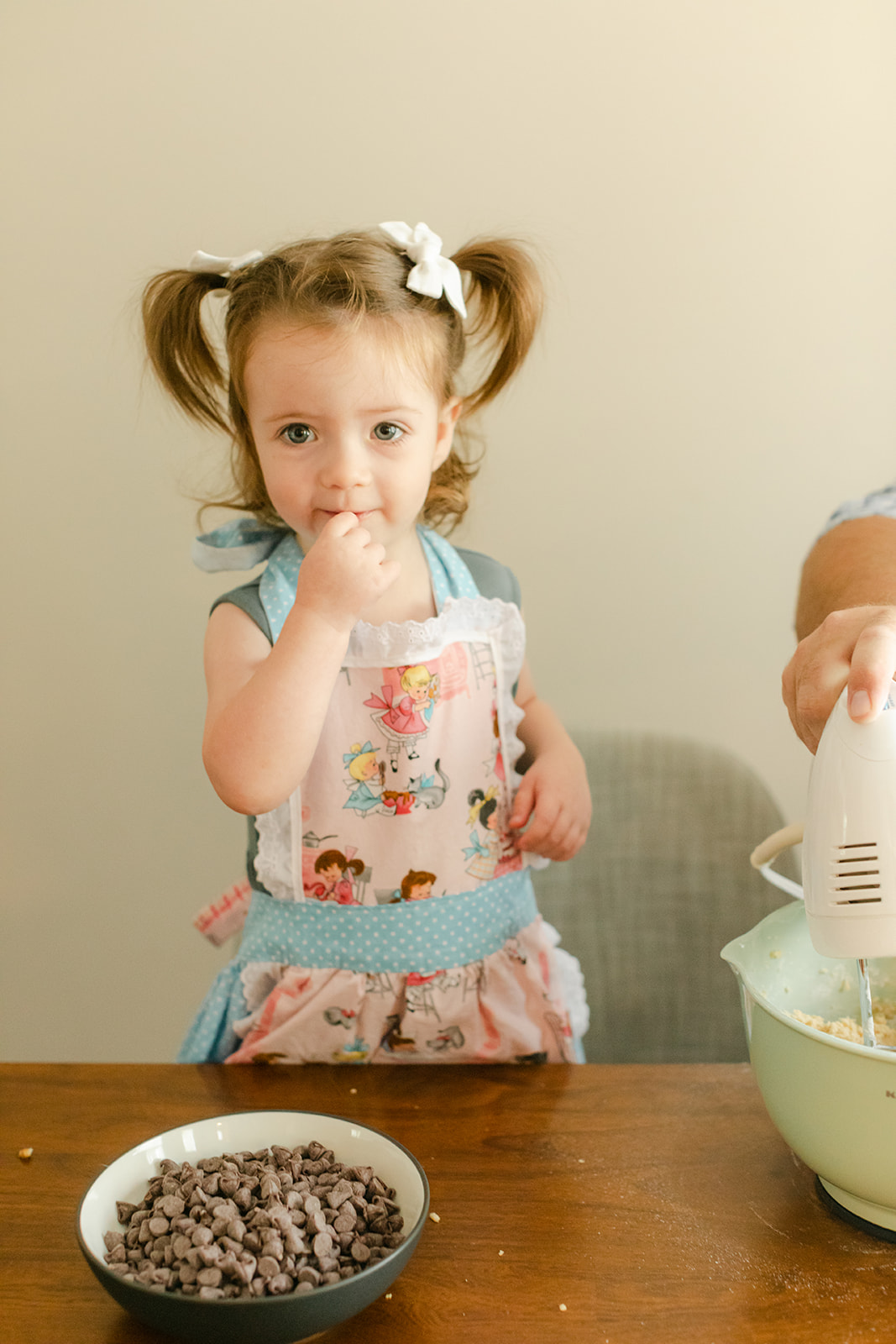 little girl baking with parents