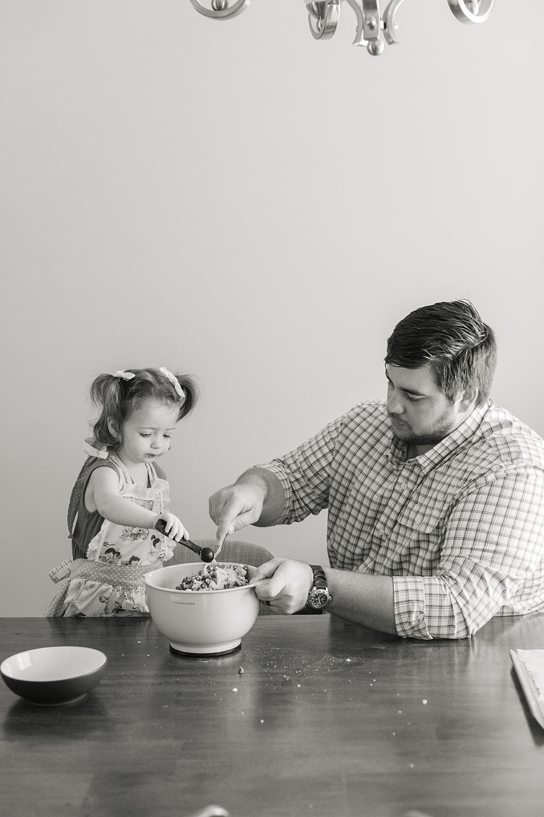 little girl baking with dad