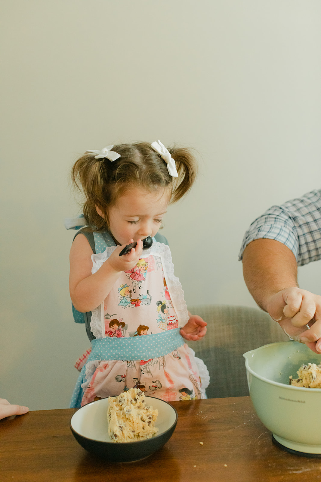 little girl eating cookie dough
