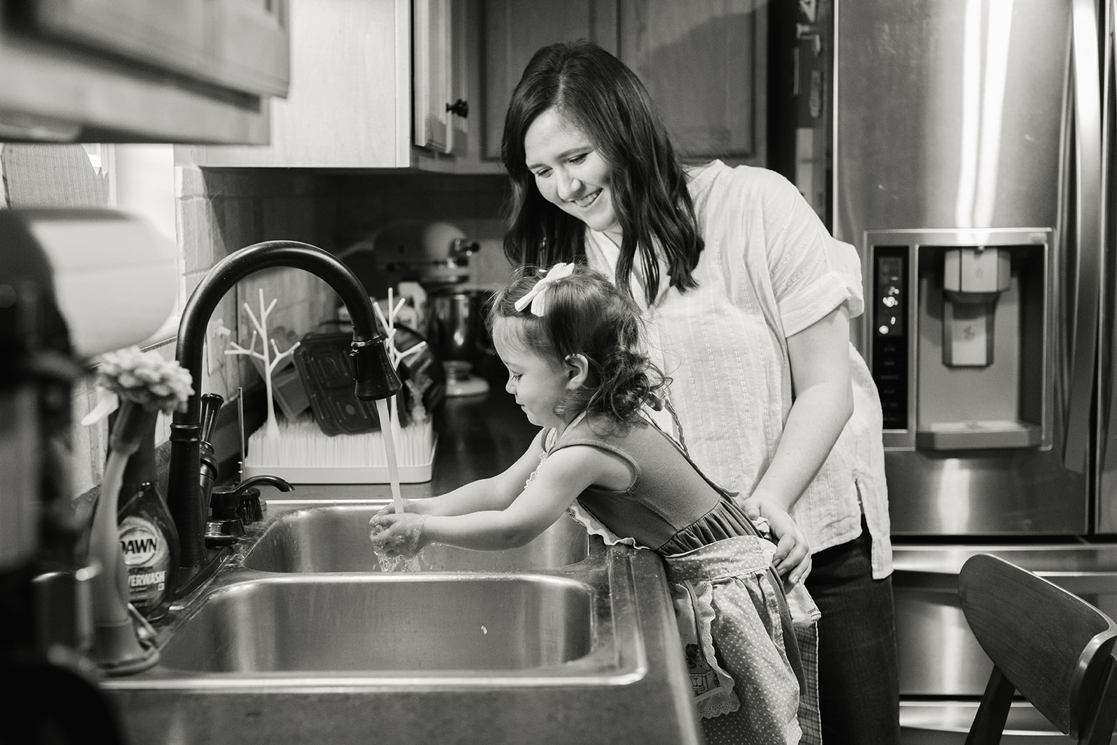 little girl washing her hands after baking cookies