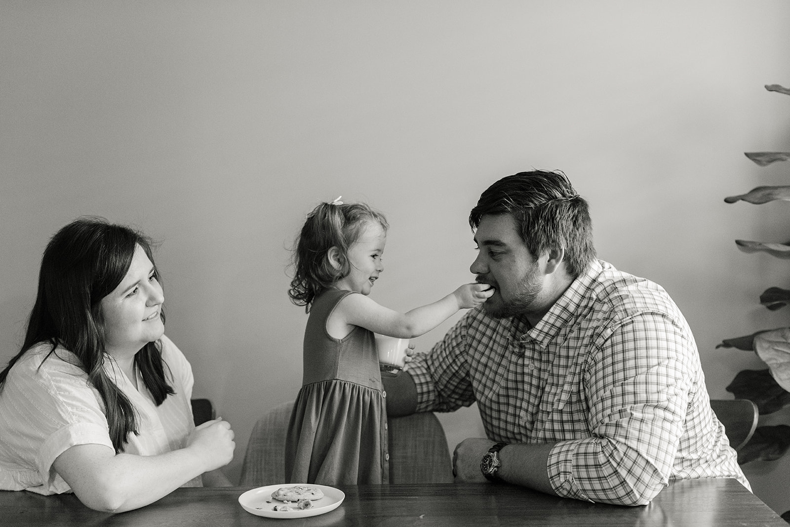 little girl giving dad cookie