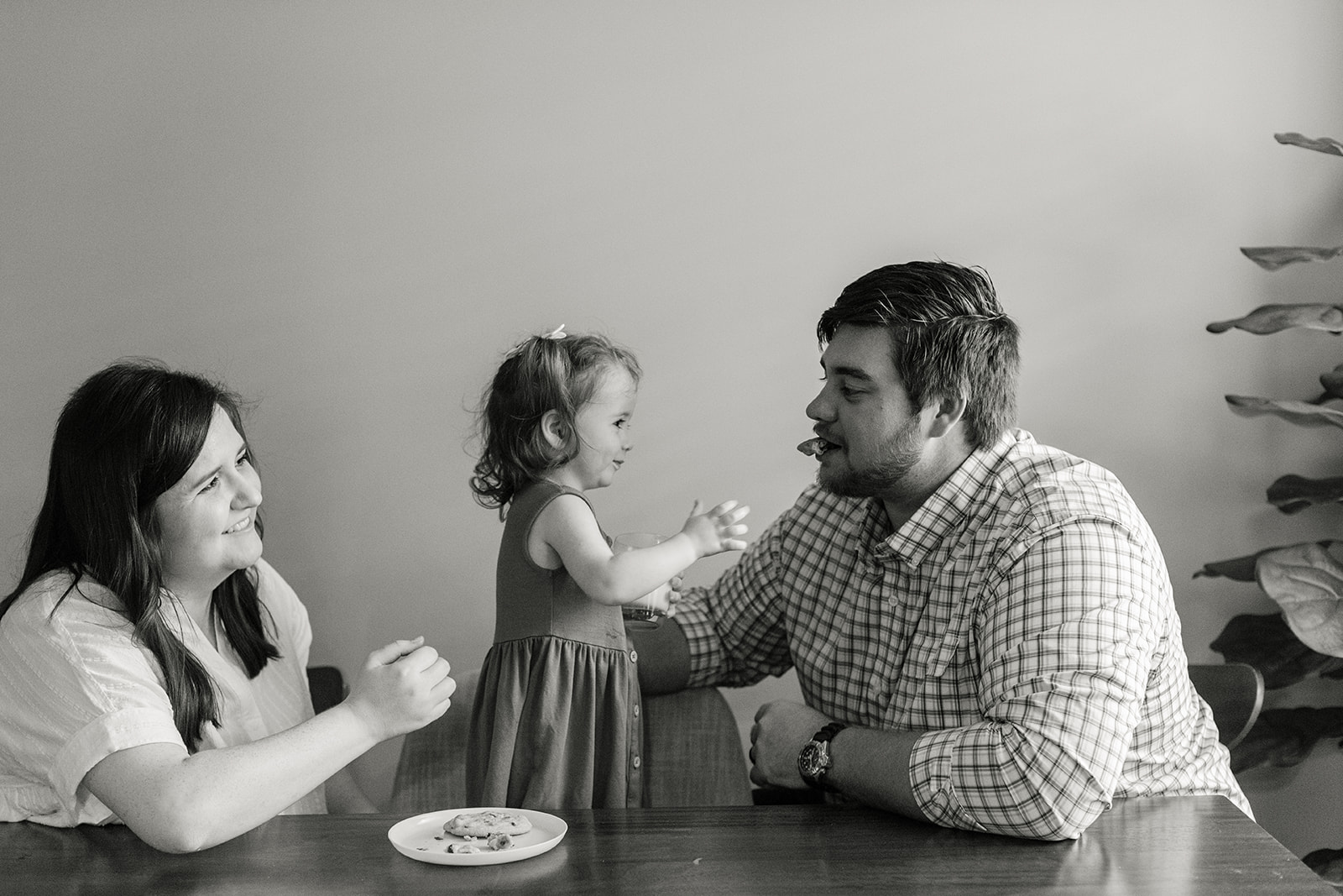 little girl giving dad cookie