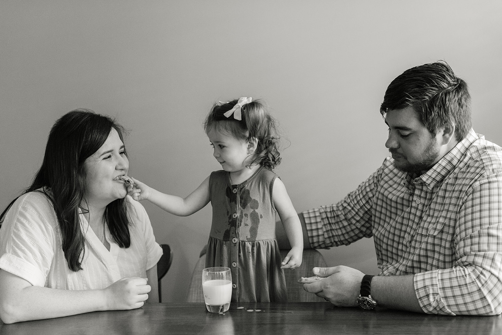 little girl giving mom cookie