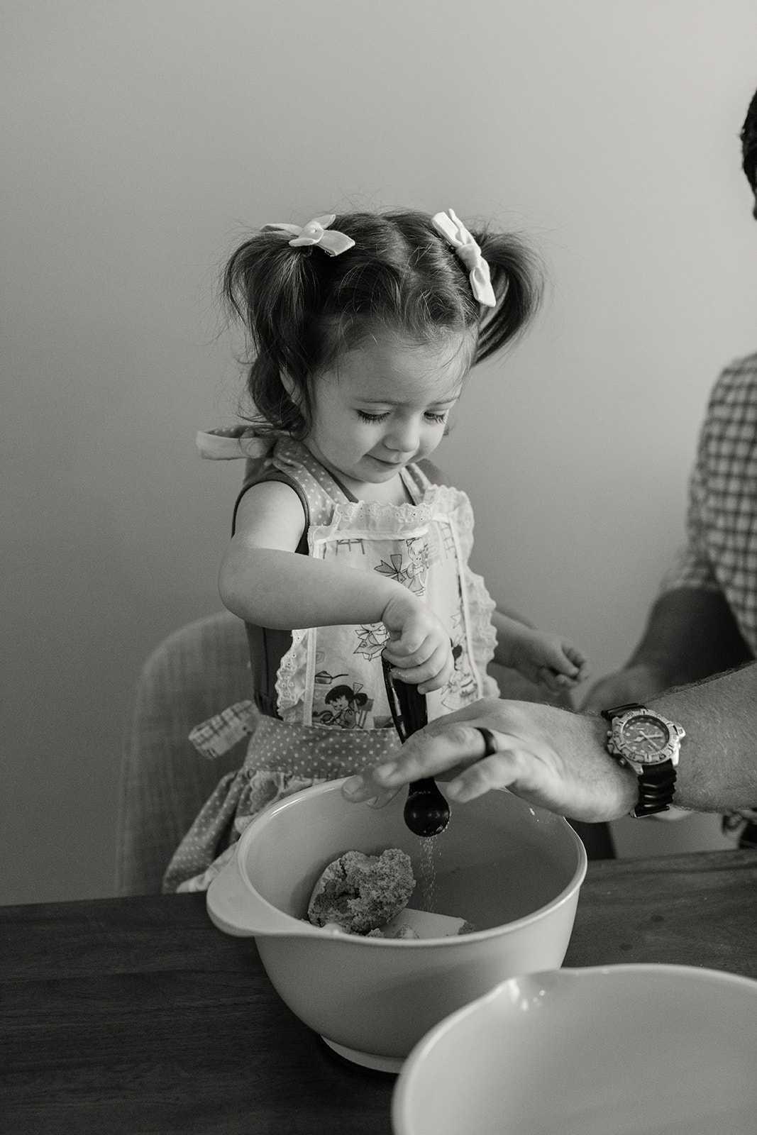 little girl baking with parents