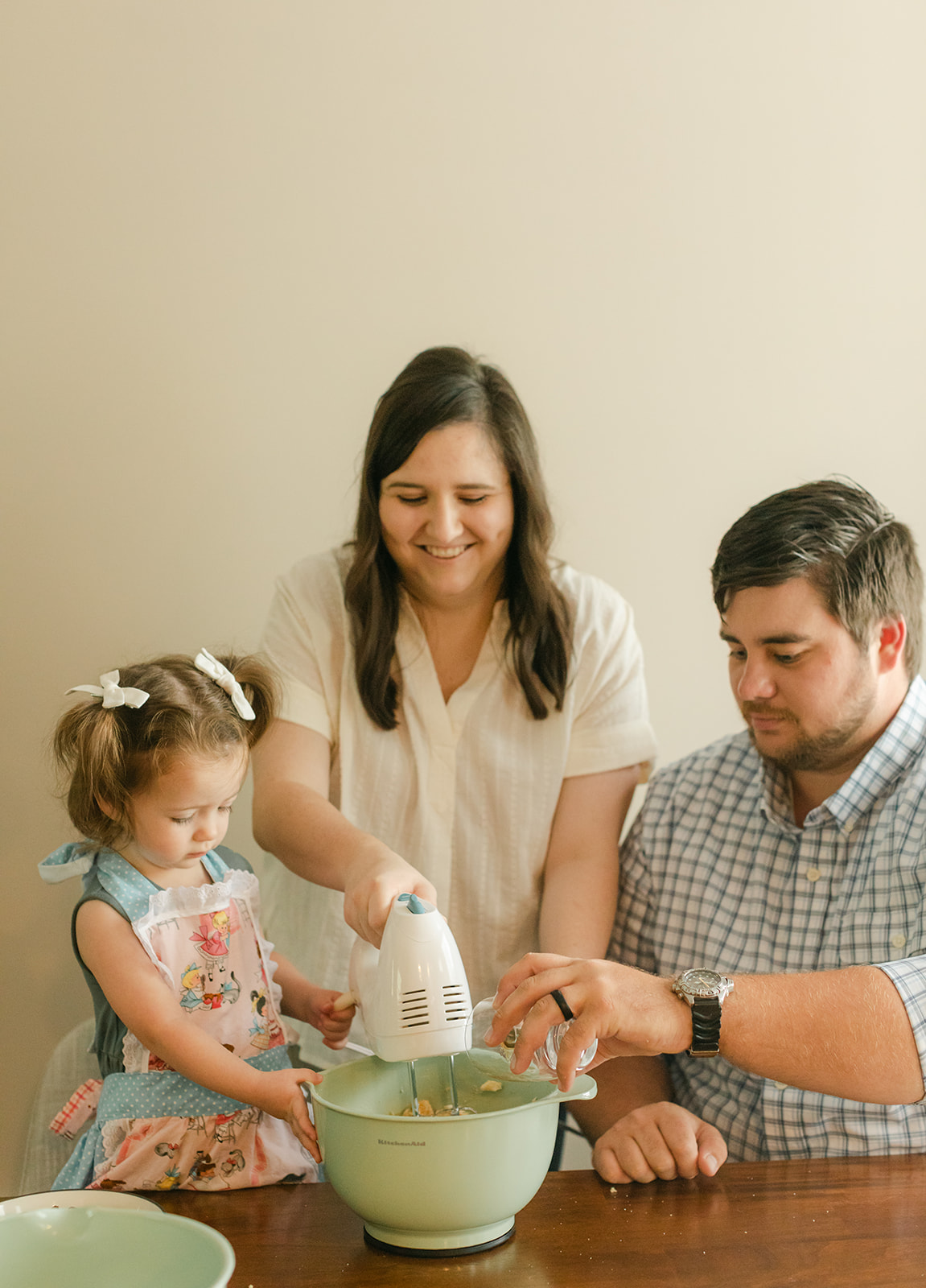 little girl baking with parents