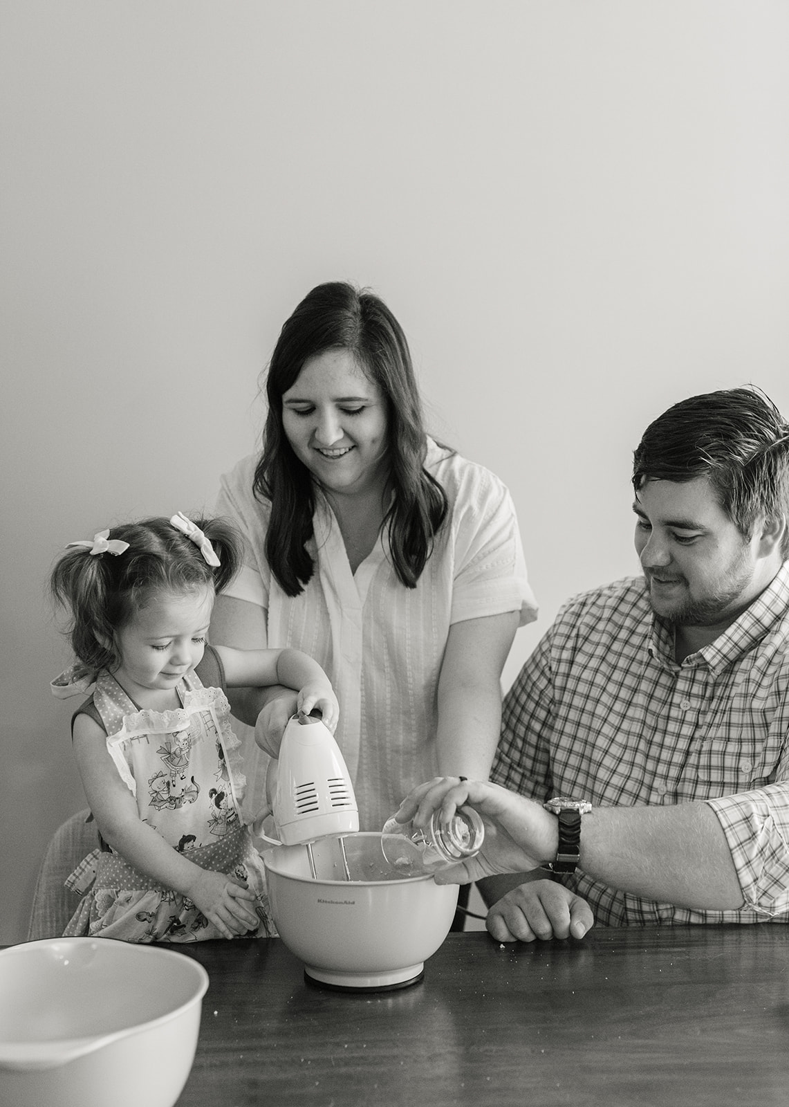 little girl baking with parents