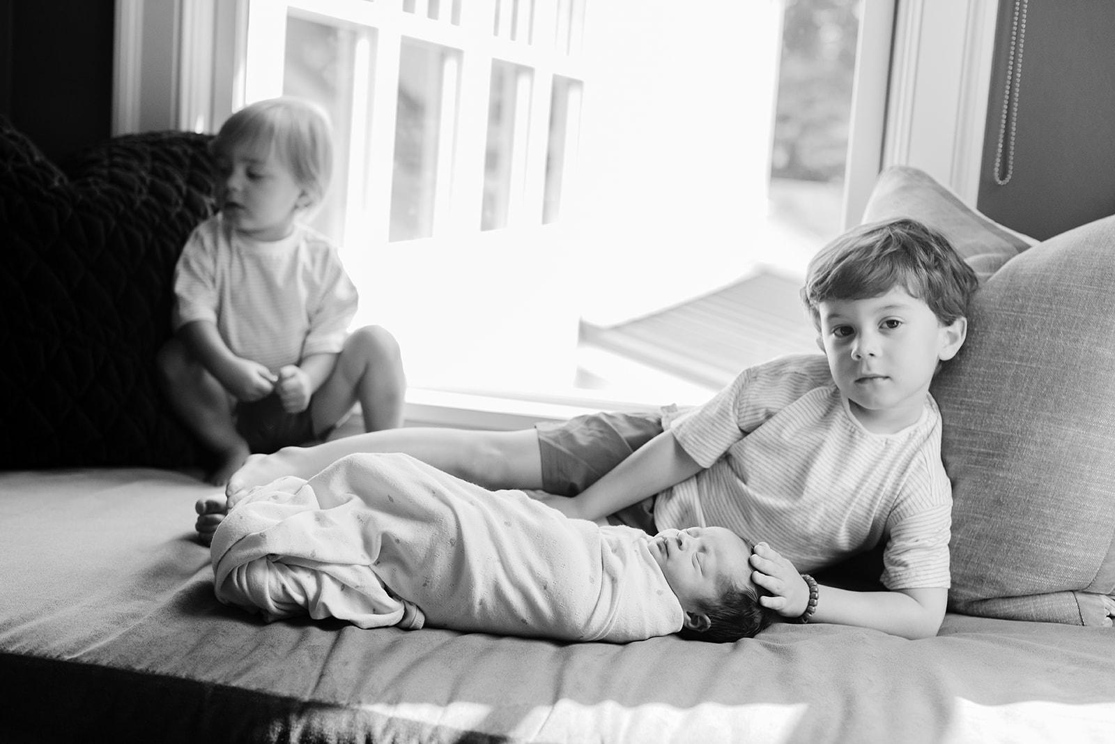 two siblings with baby sister