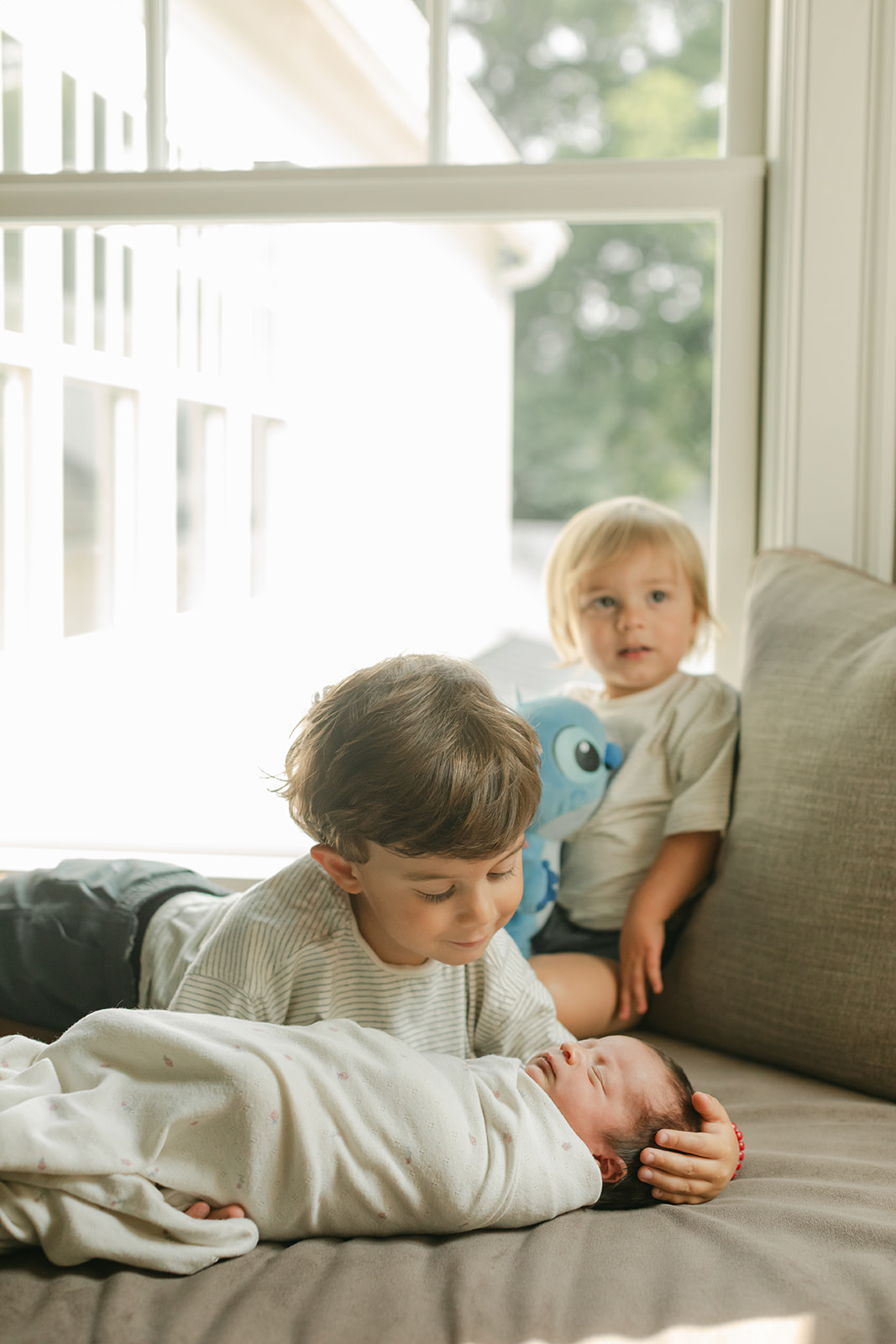 two siblings with baby sister