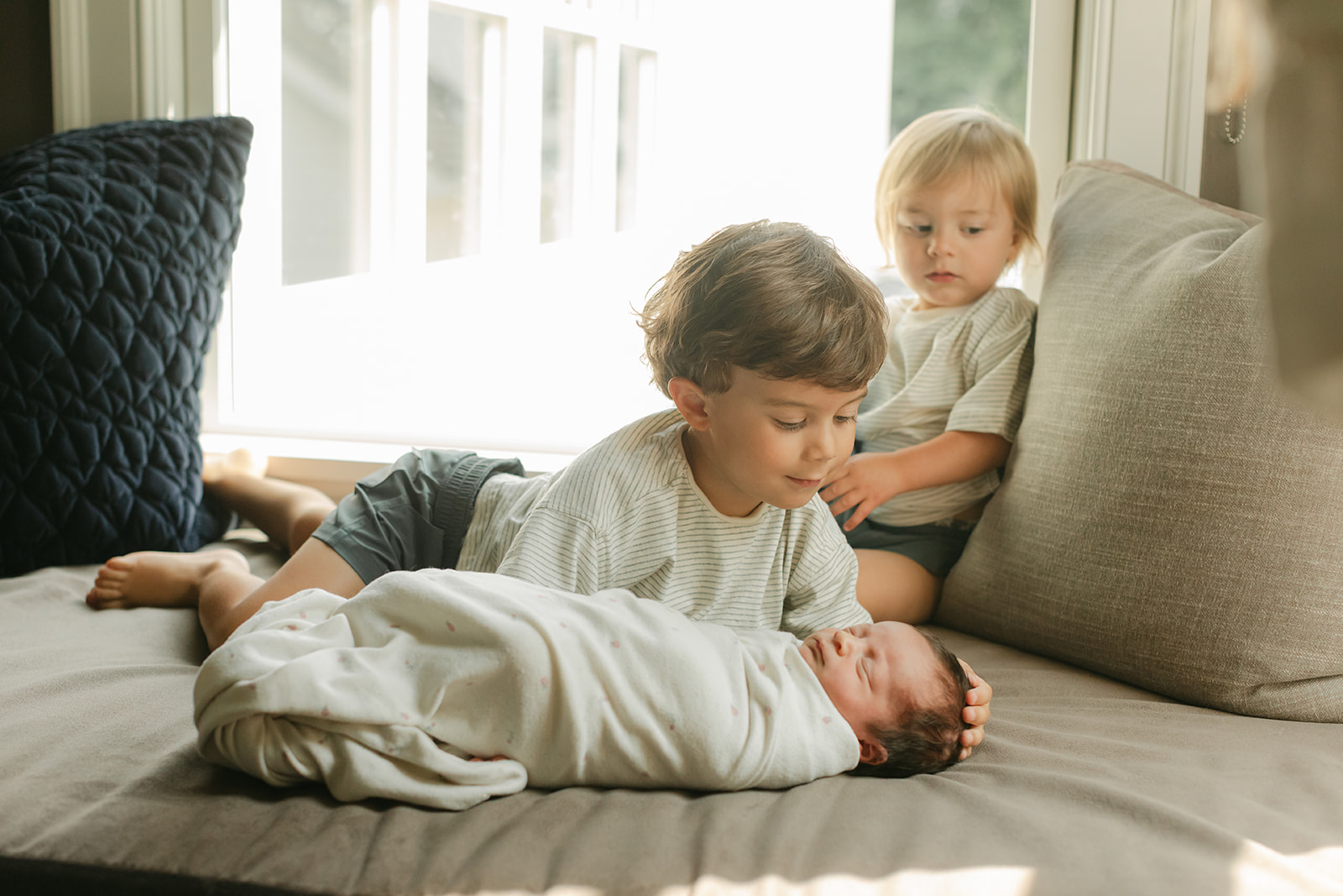 two siblings with baby sister