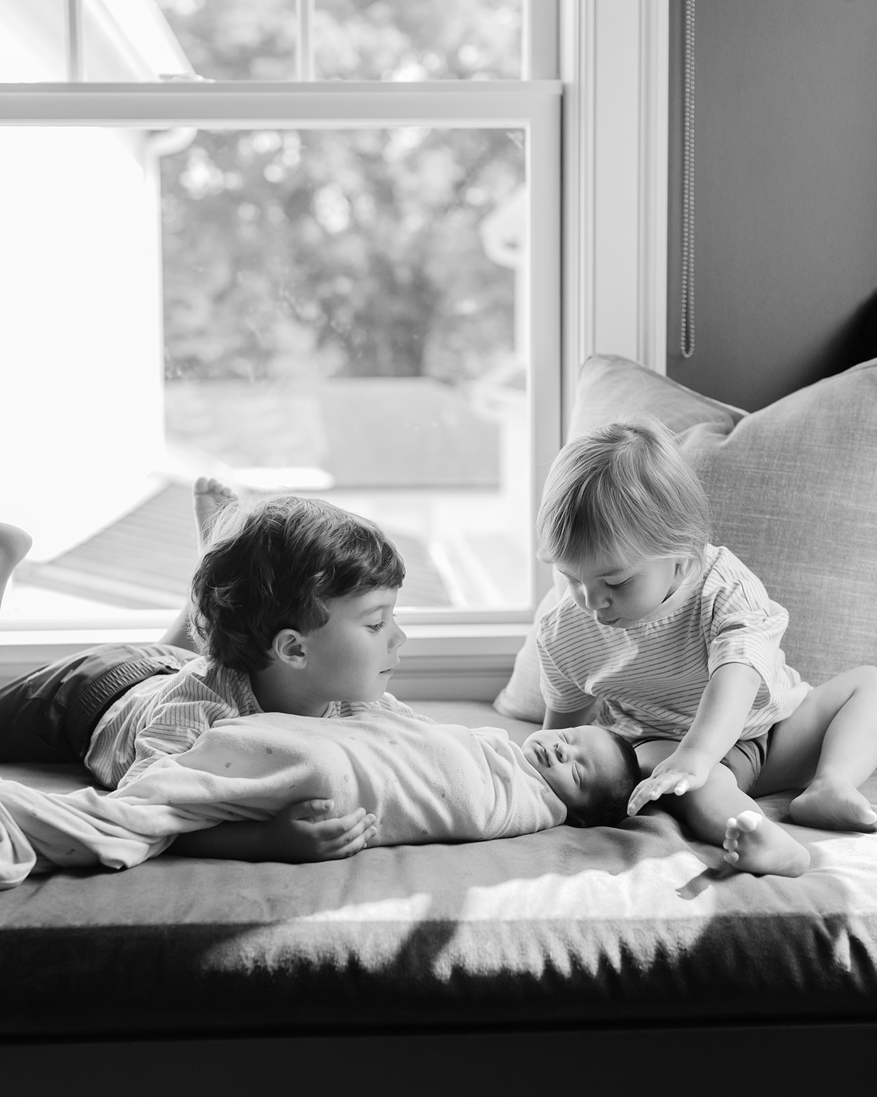 two big brothers with newborn baby sister