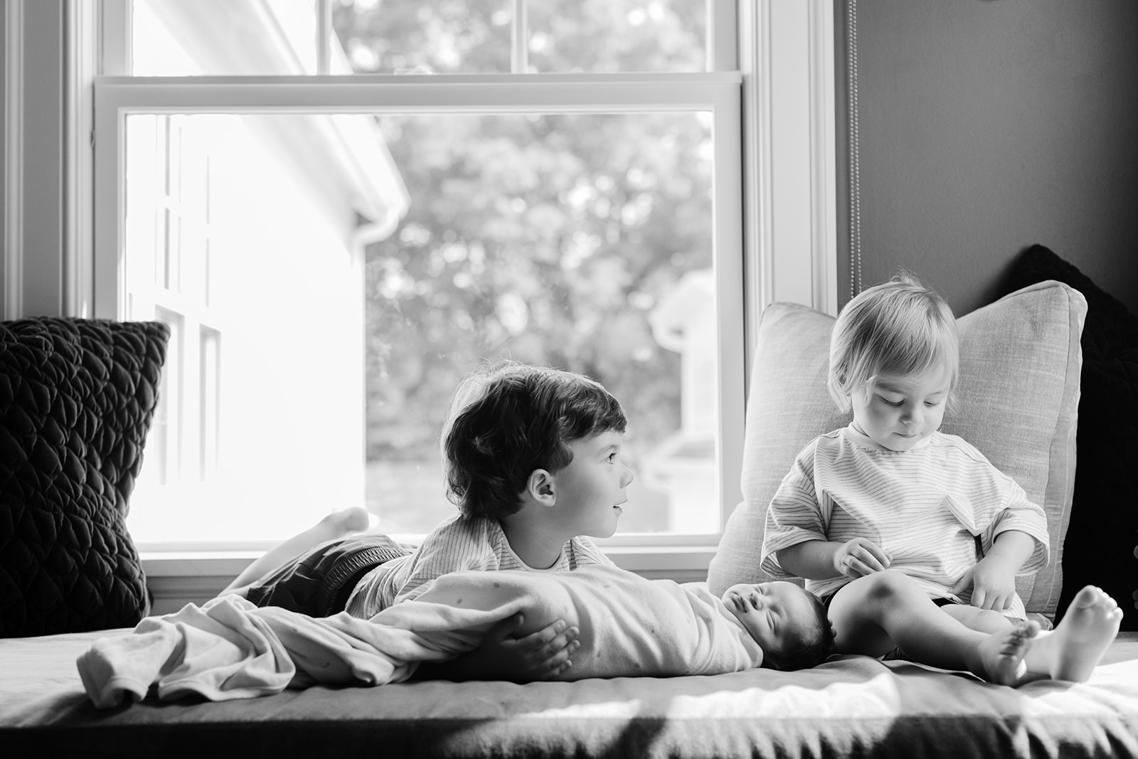 two big brothers with newborn baby sister