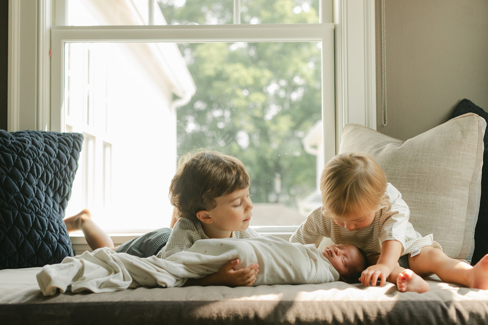 two big brothers with newborn baby sister