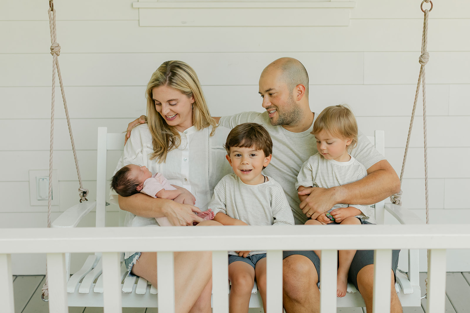 family in front porch. family photos during newborn session 