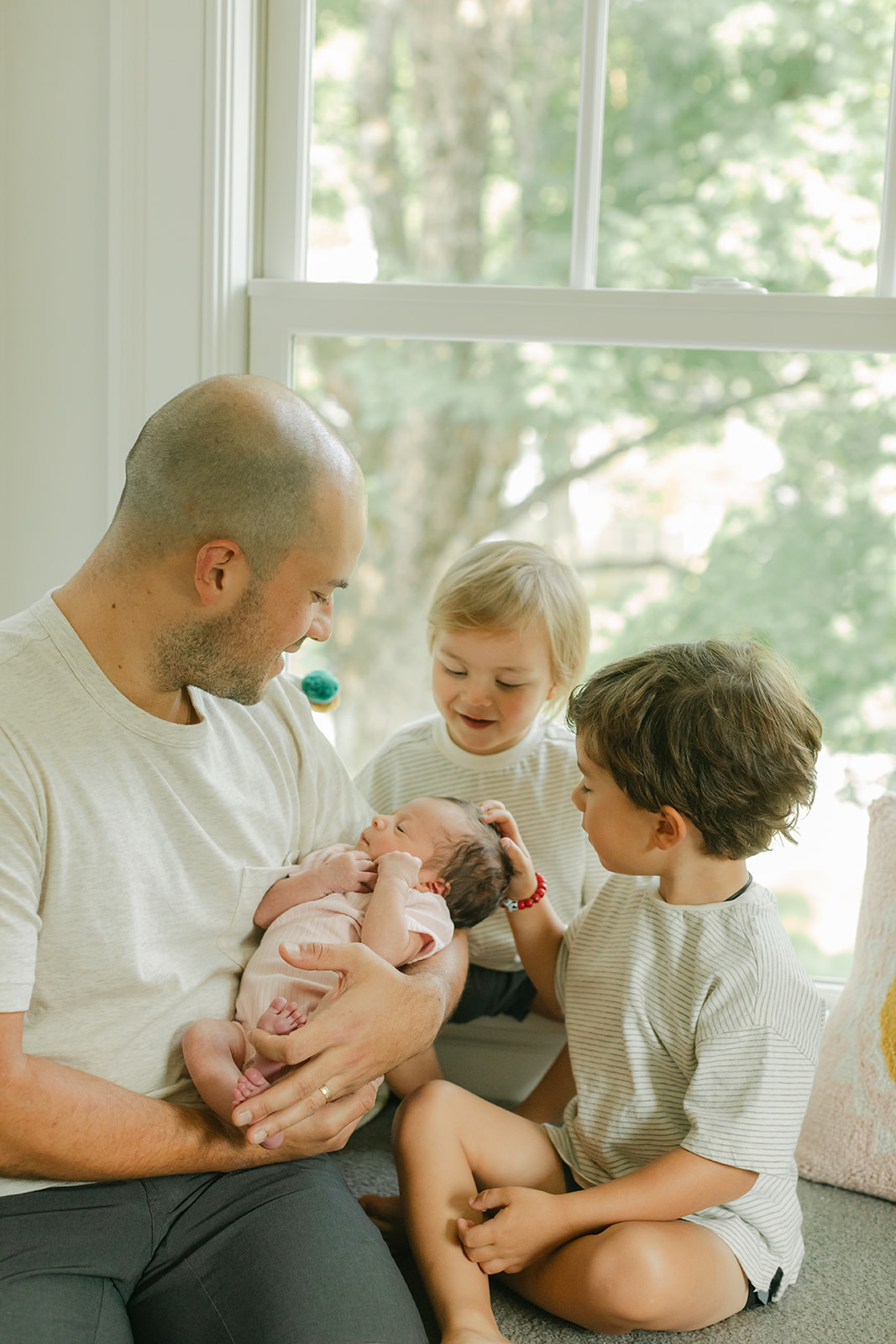 dad and his two young boys and newborn daughter