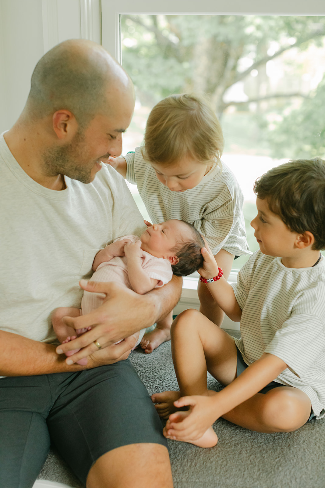 dad and his two young boys and newborn daughter