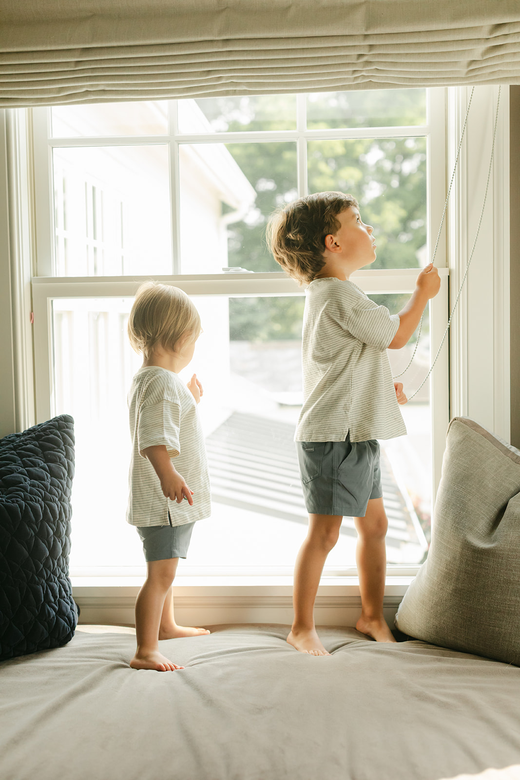 two little brothers on window sill