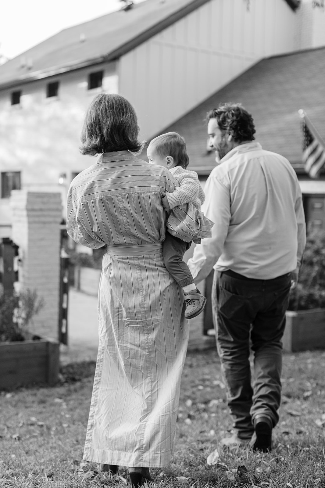 outdoor fall family session. parents and baby boy walking