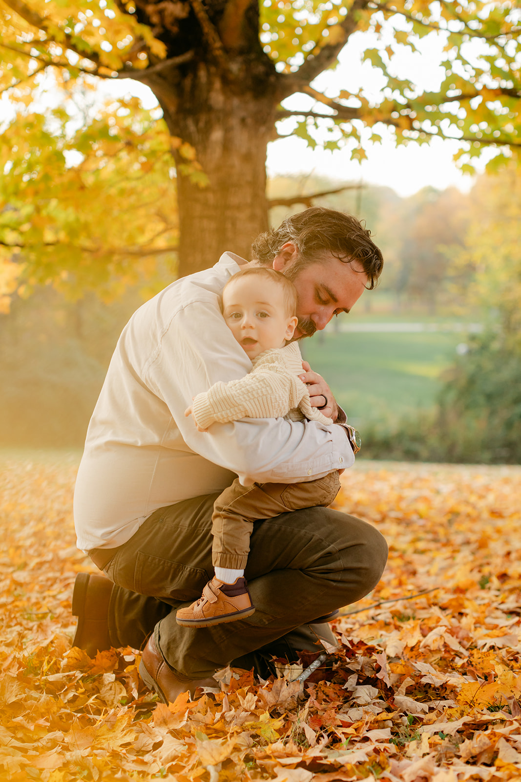 outdoor fall family session. dad hugging son