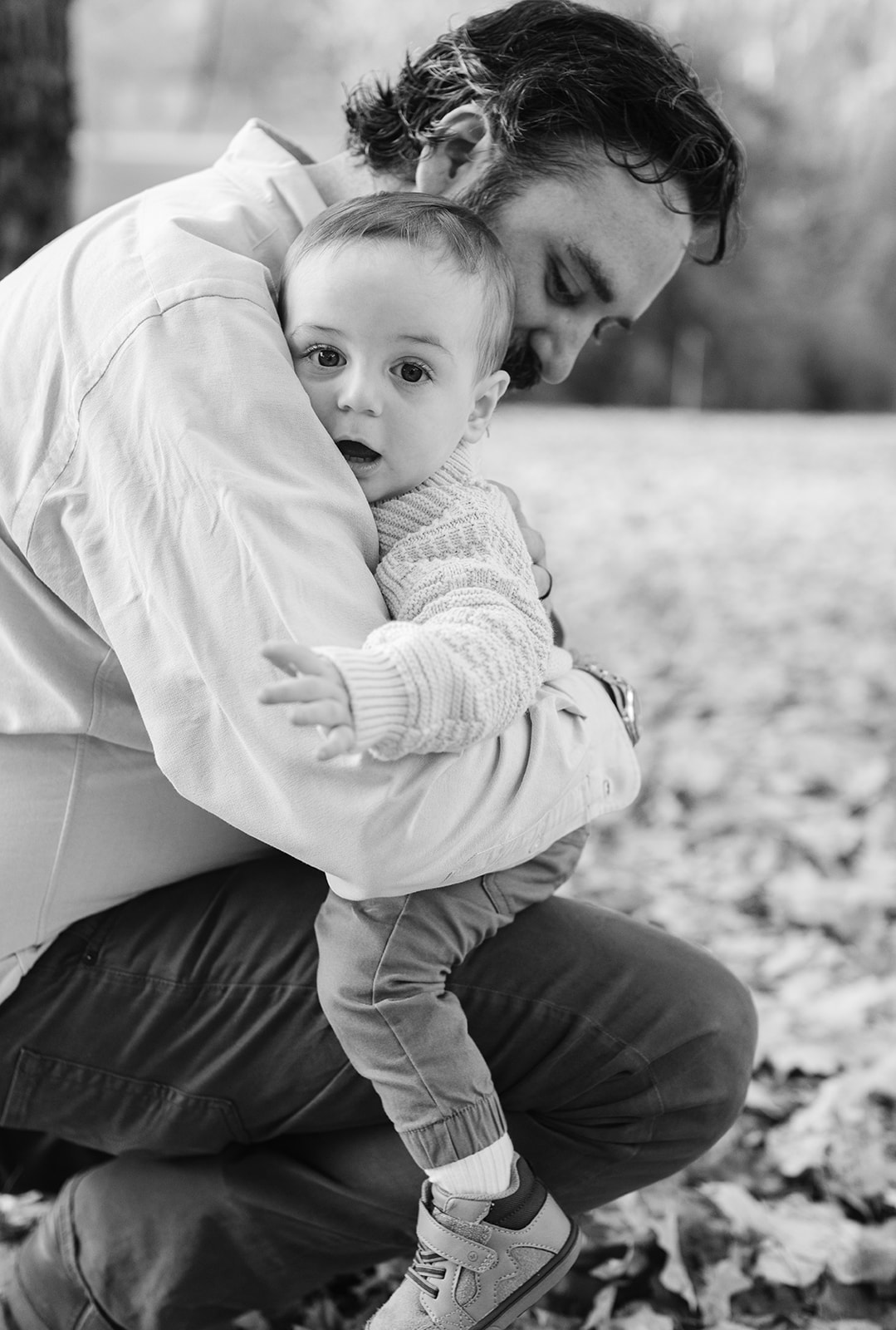 outdoor fall family session. dad hugging son