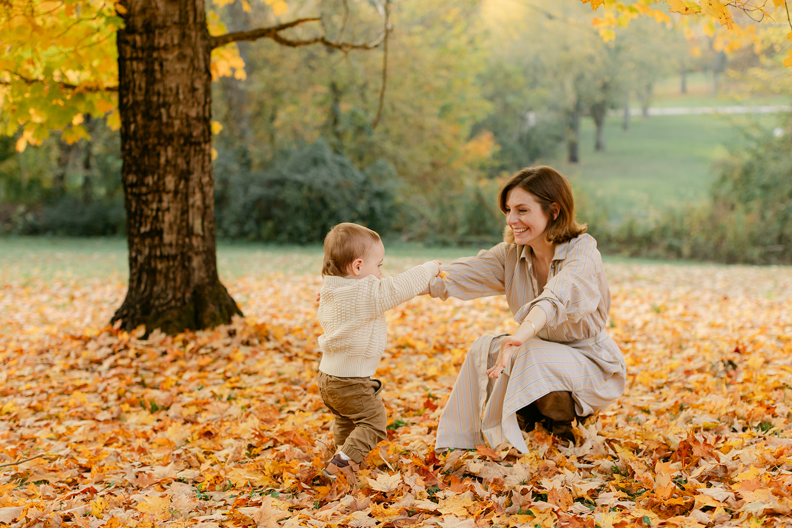 outdoor fall family session. little boy running to mom
