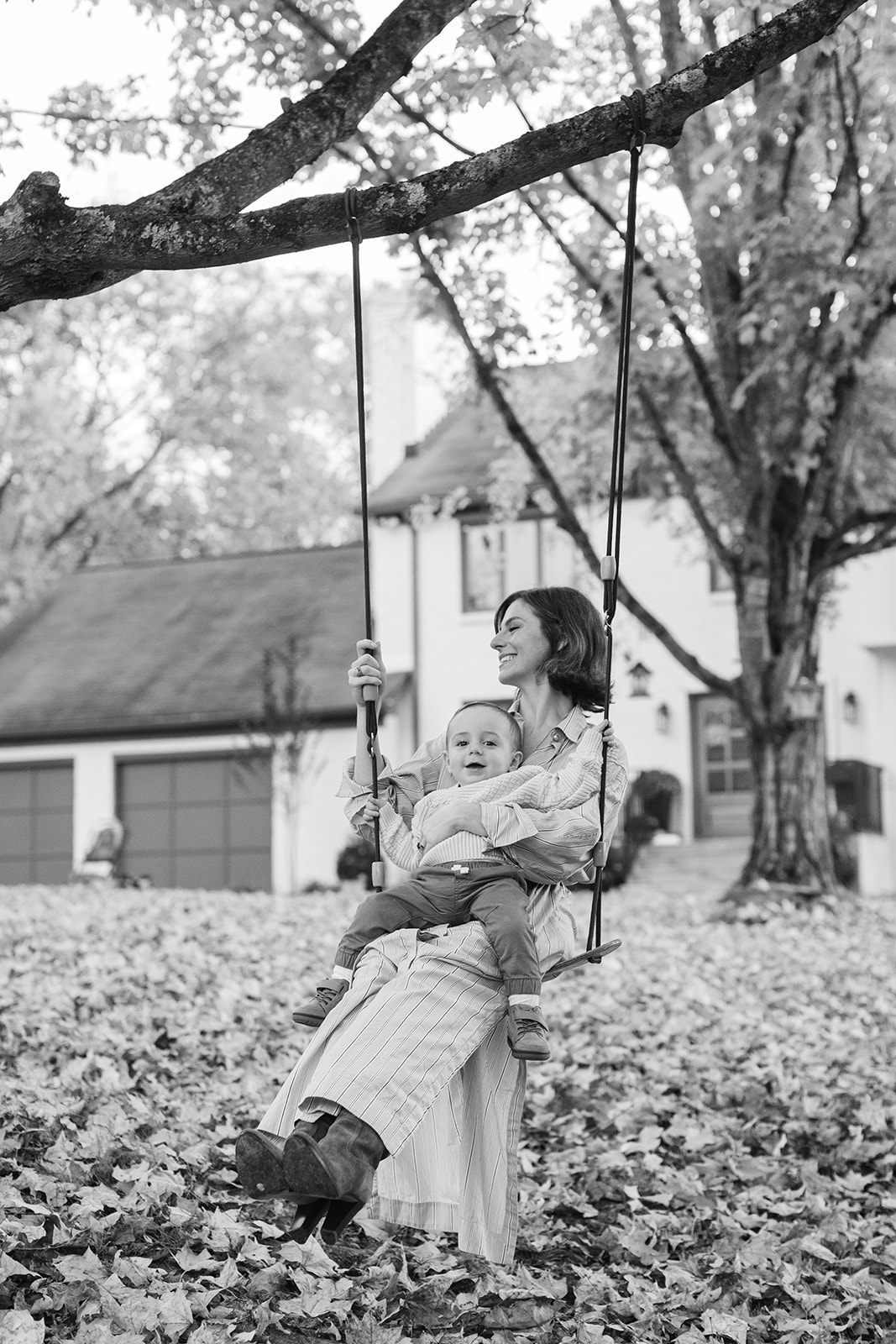 outdoor fall family session. mama and young boy on swing
