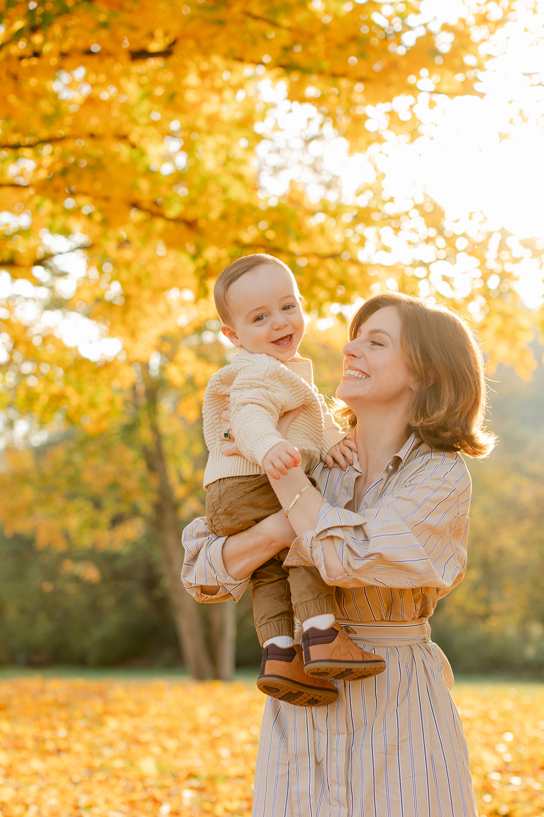 outdoor fall family session. smiling mama and baby boy