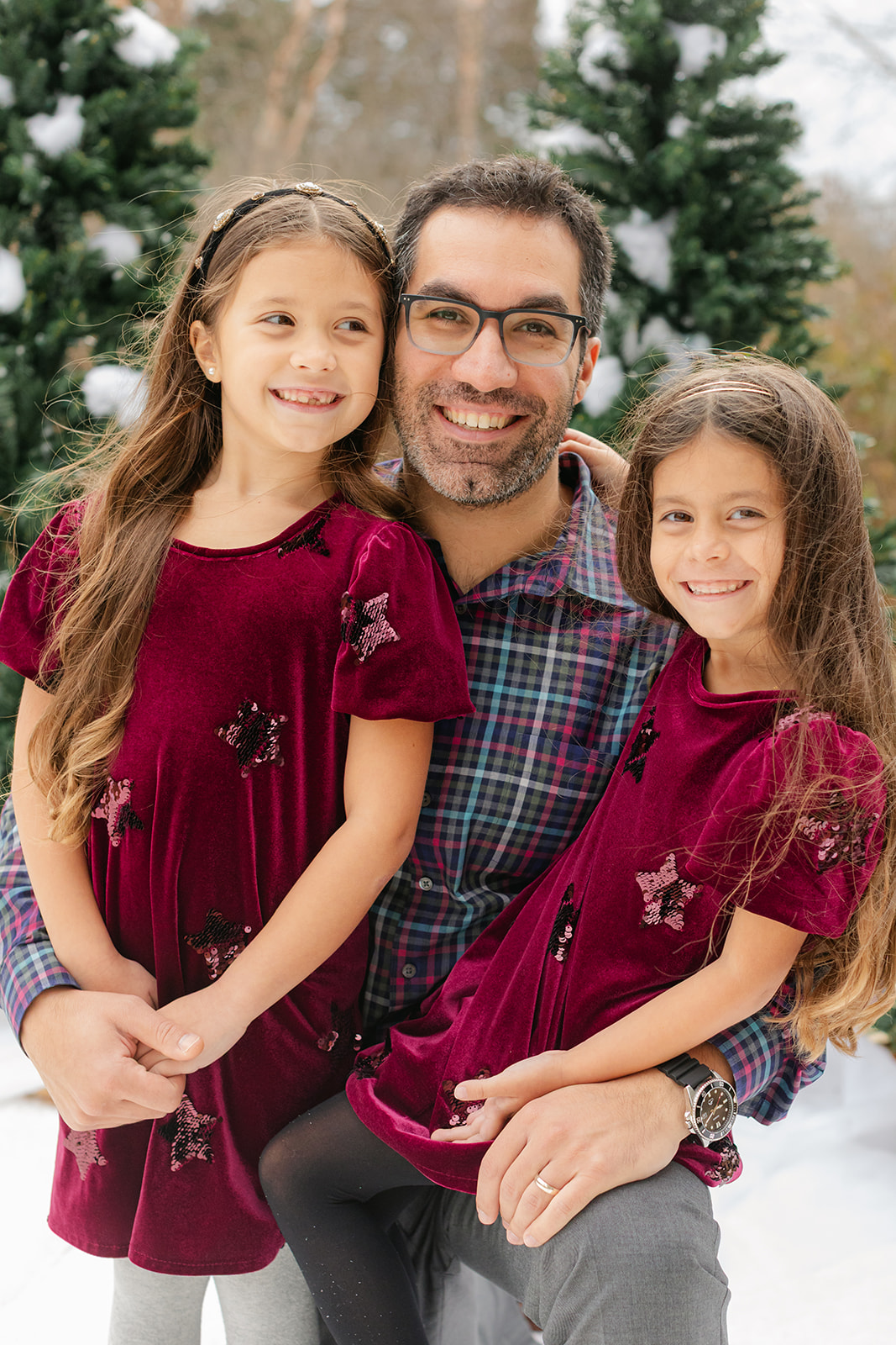 dad and his two daughters. snowy christmas family photos