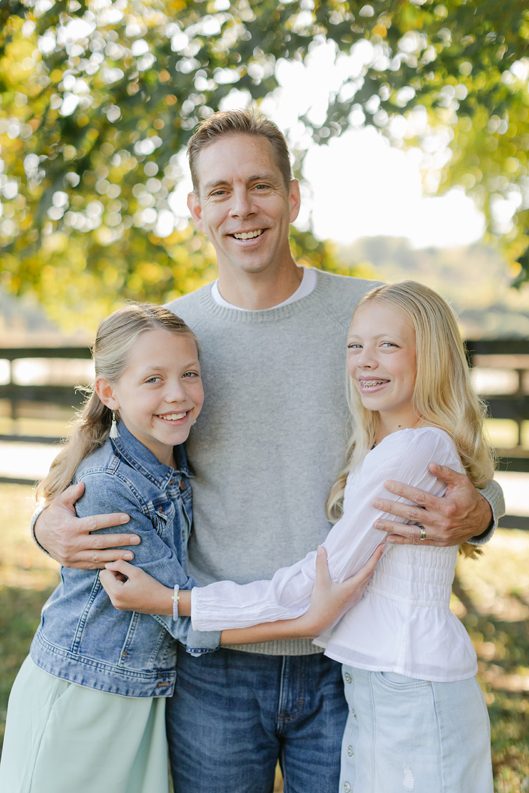 dad and two tween (teenager) daughters during outdoor family photos