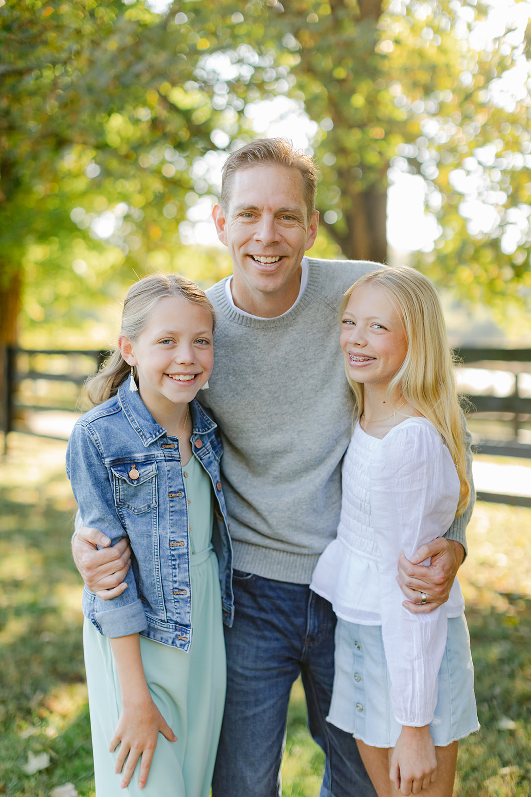 dad and two tween (teenager) daughters during outdoor family photos