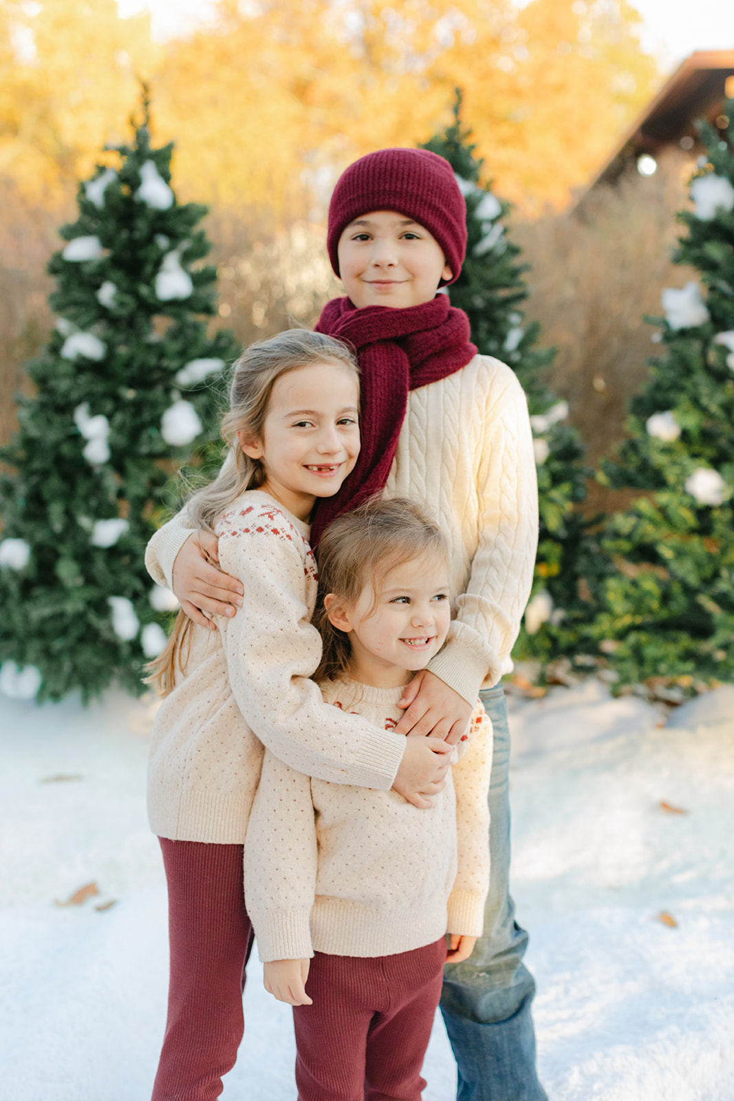 three siblings. outdoor christmas family photo.