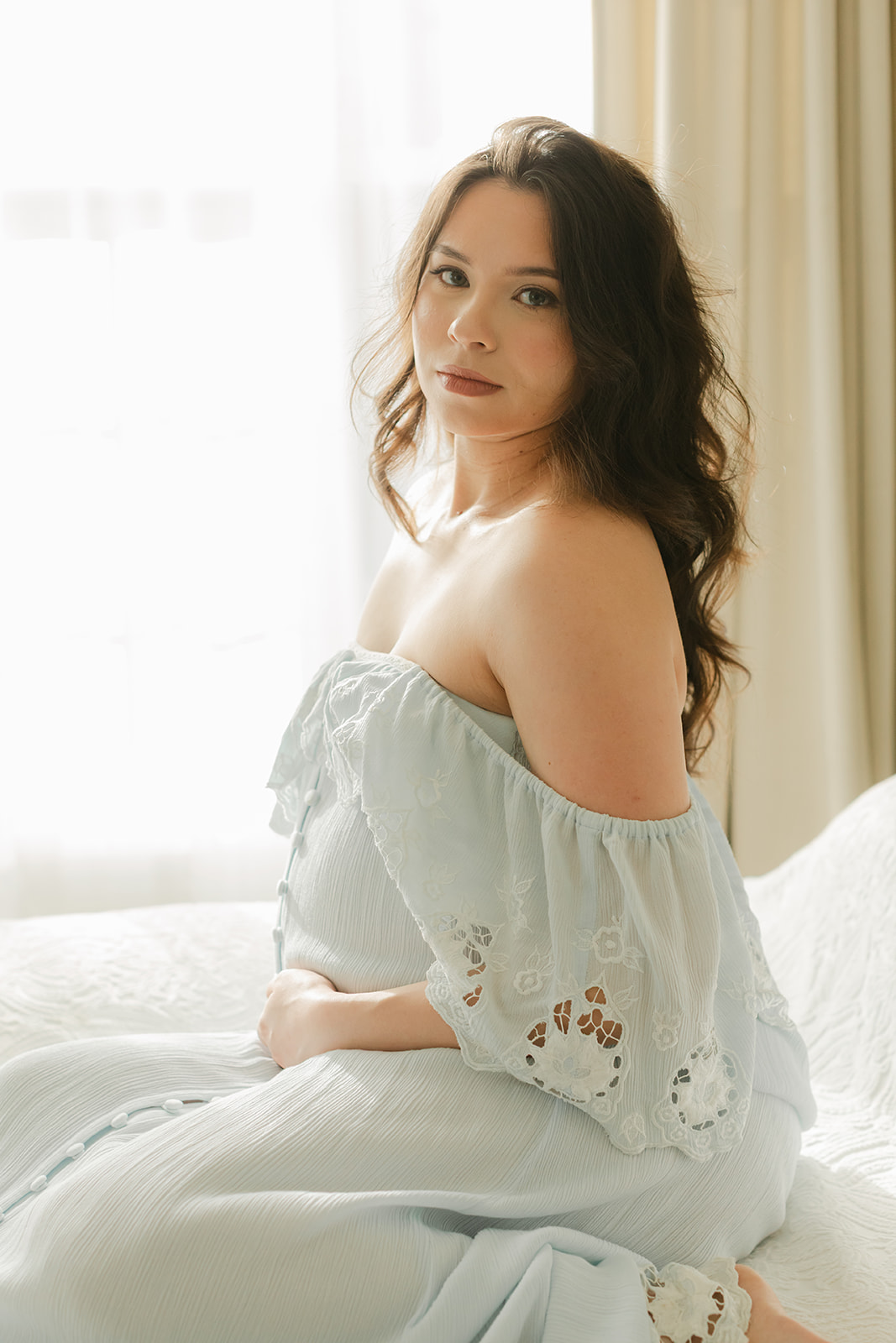 Maternity session. Woman in light blue dress