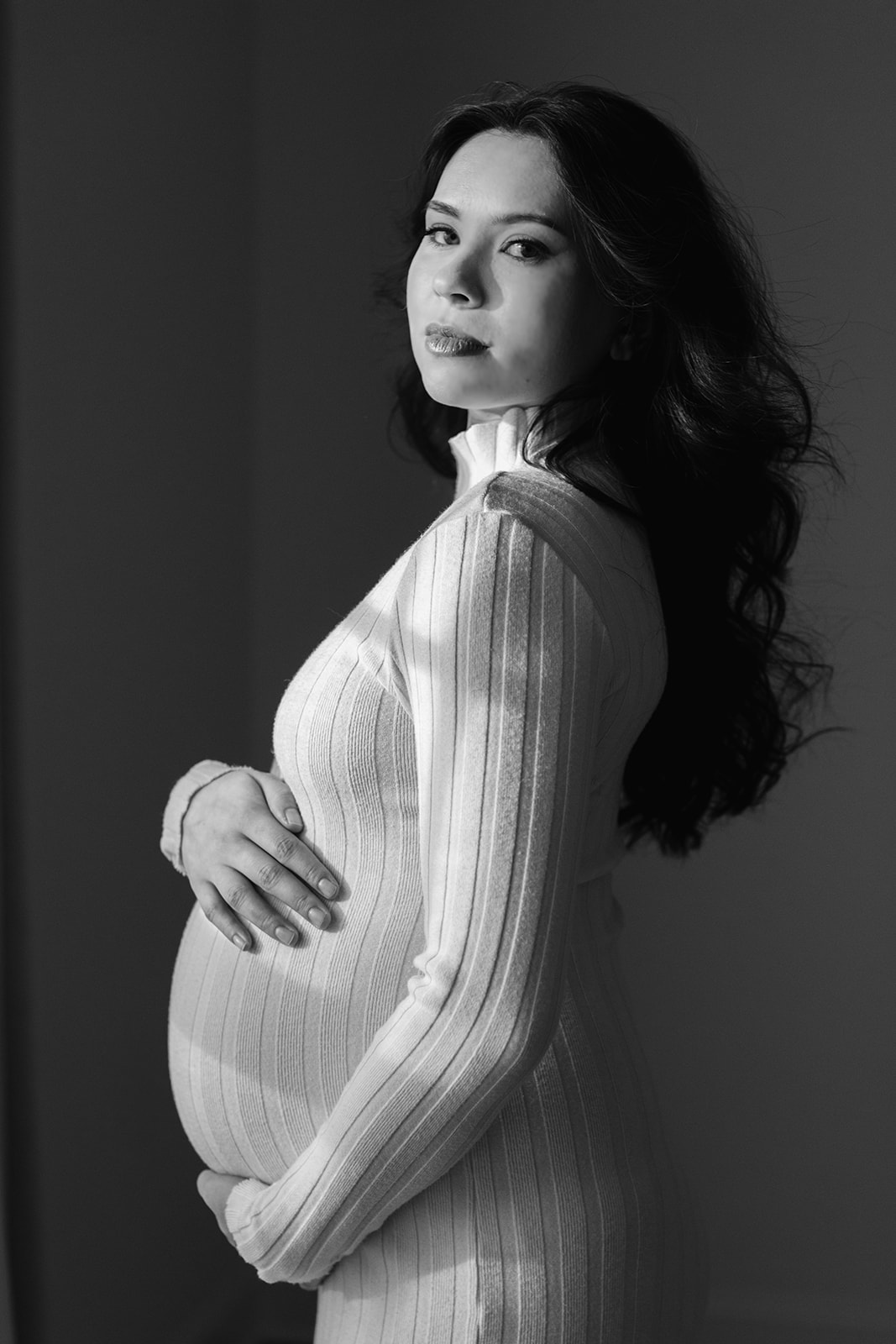Maternity session. Woman in white bodycon dress