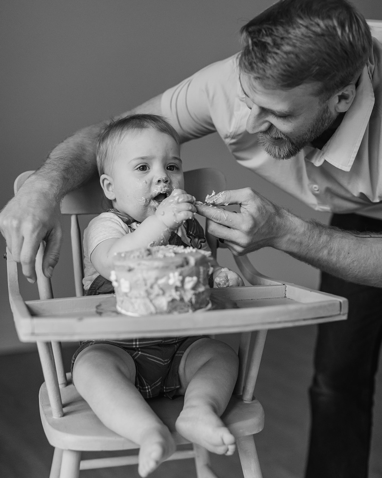 dad and son with birthday cake