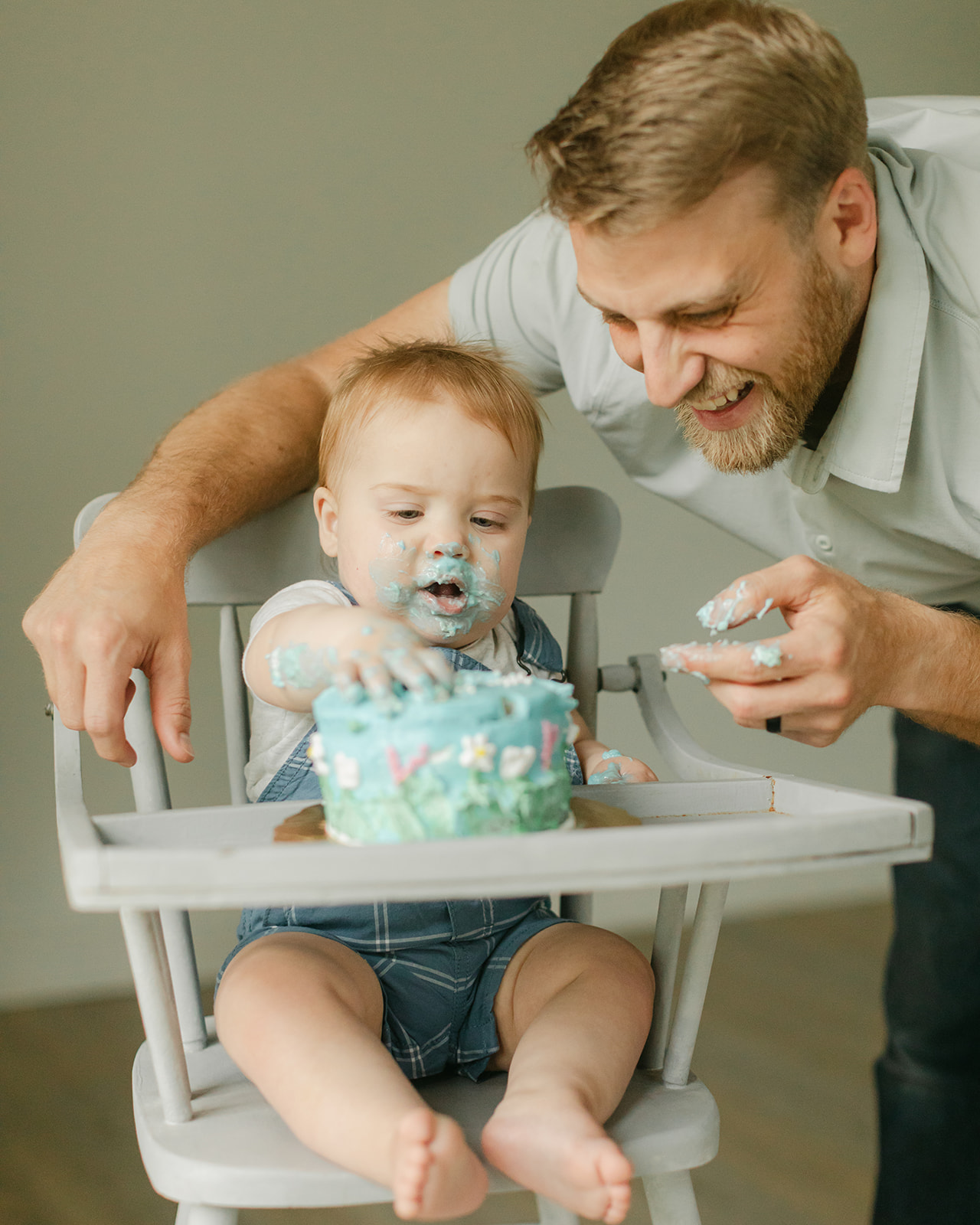 dad and son with birthday cake