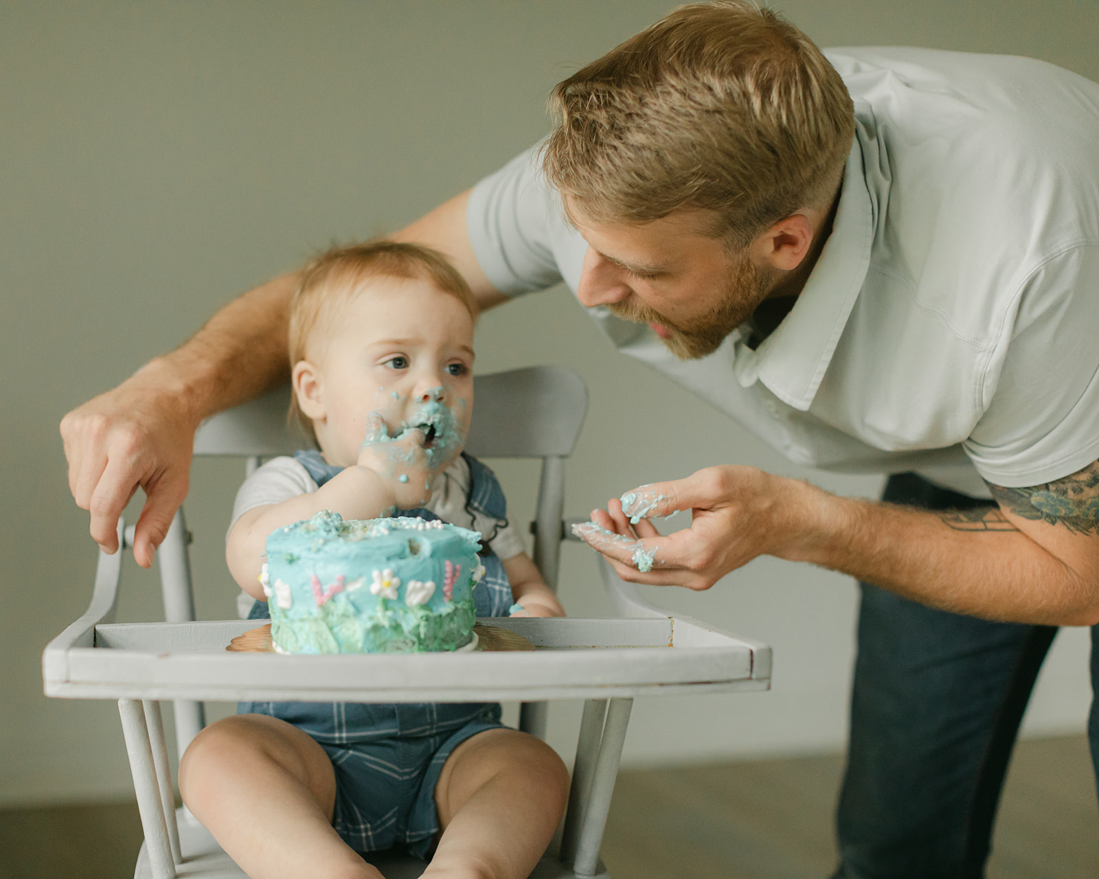 dad and son with birthday cake