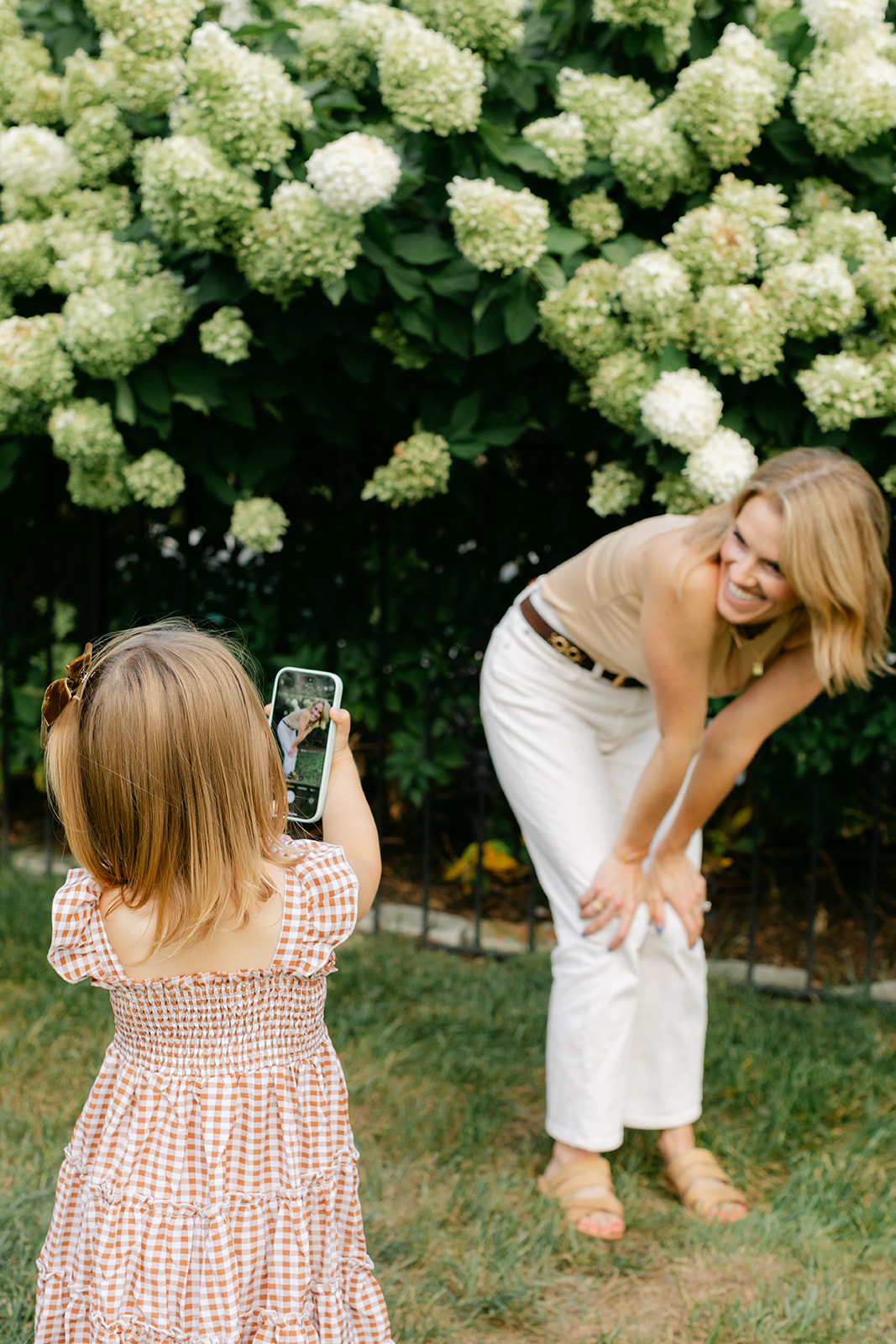 little girl taking photo of mom