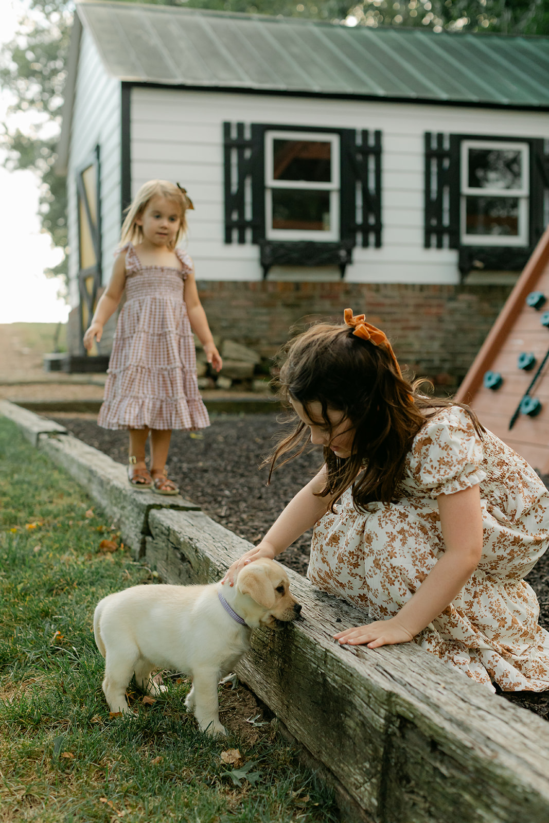two sisters and new puppy on playground