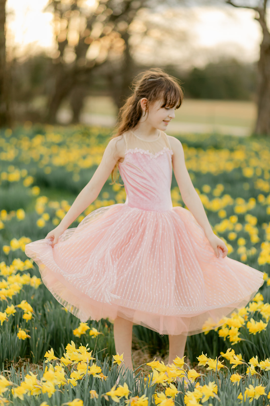 little girl running in daffodil field
