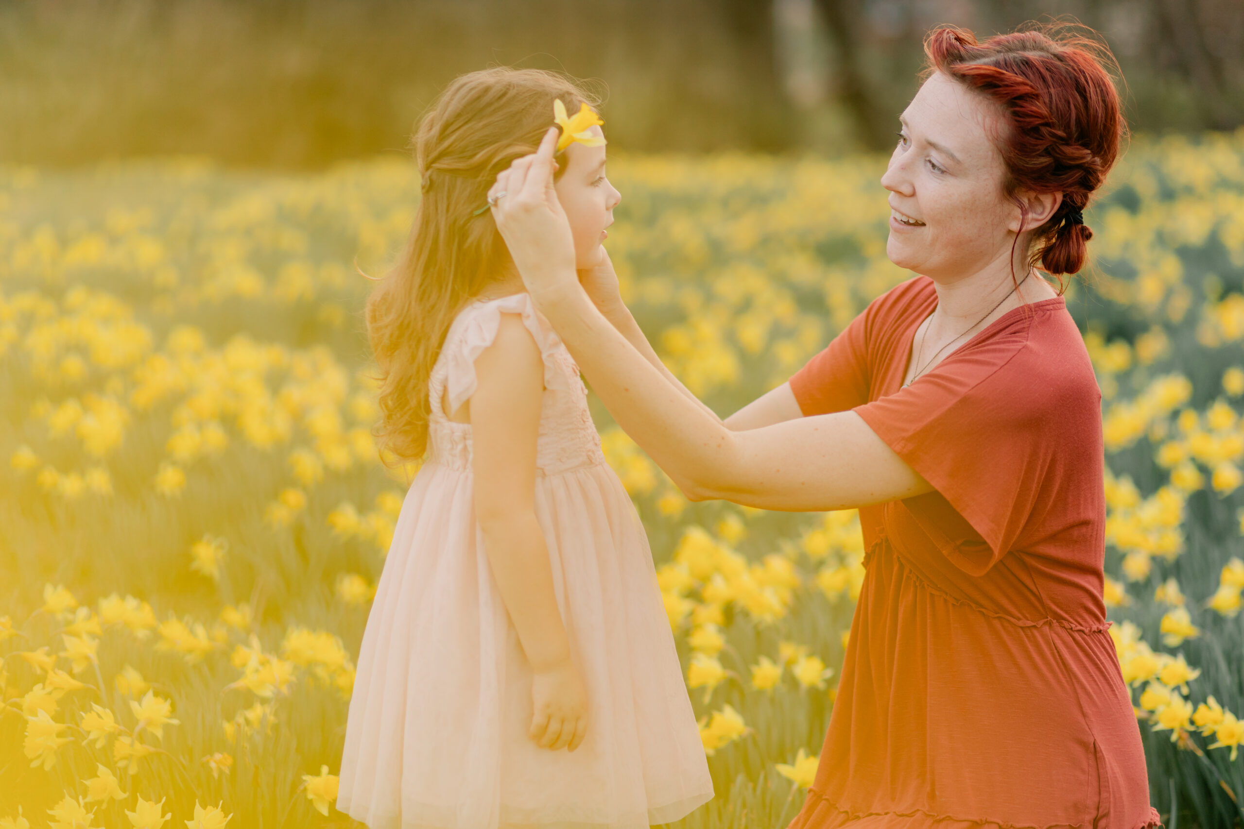 mama and daughter in daffodil field