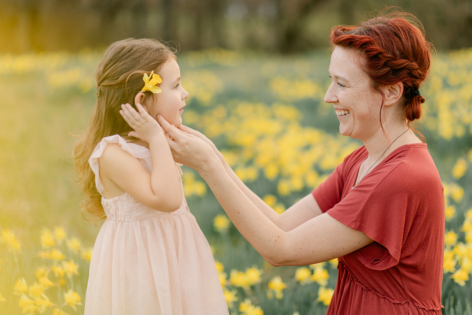 mama and daughter in daffodil field