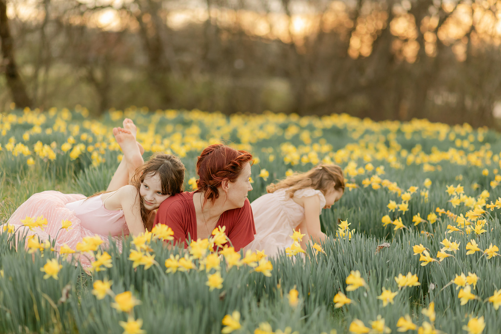 mama and daughters in daffodil field