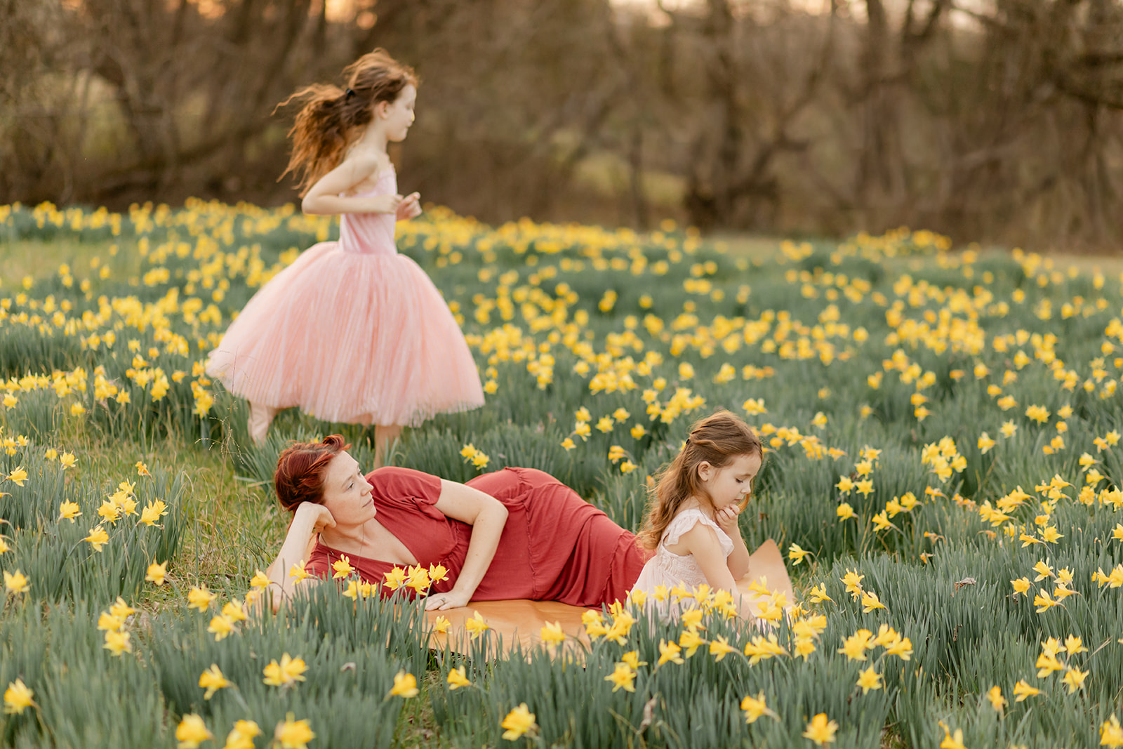 mama and daughters in daffodil field