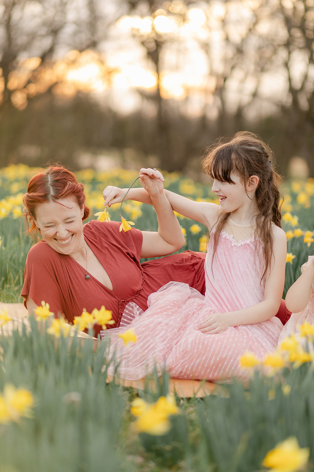 mama and daughter in daffodil field