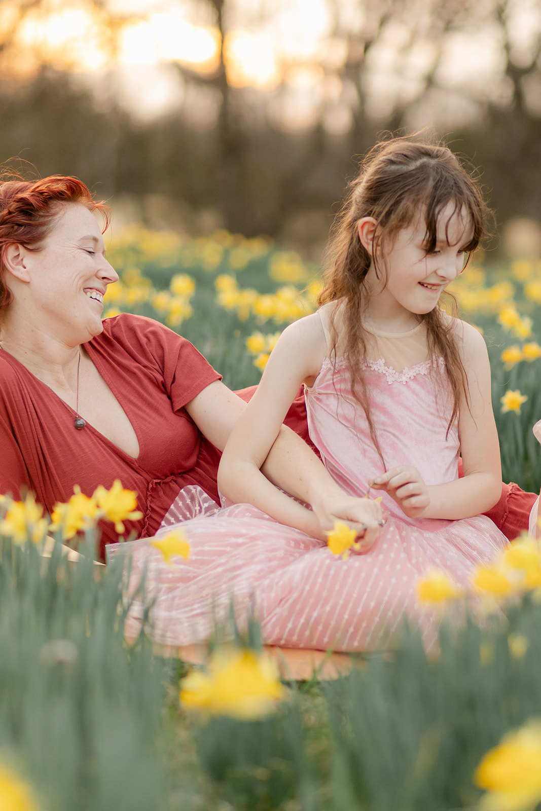 mama and daughter in daffodil field
