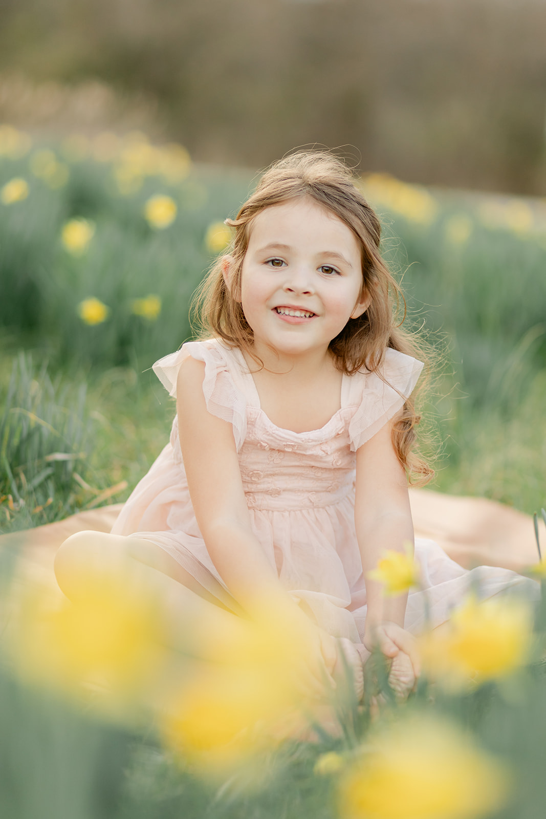 little girl in daffodil field