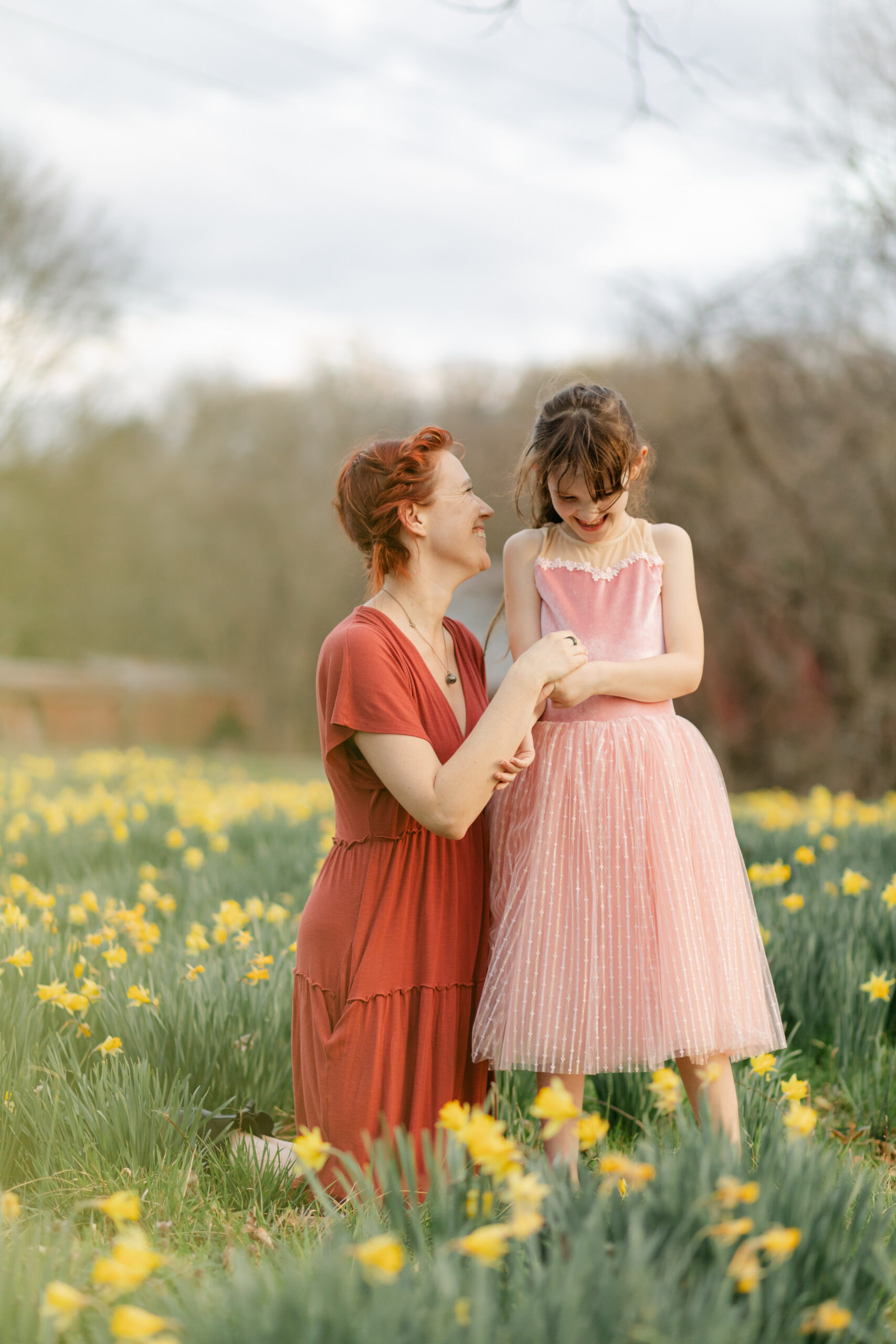 mama and daughter in daffodil field