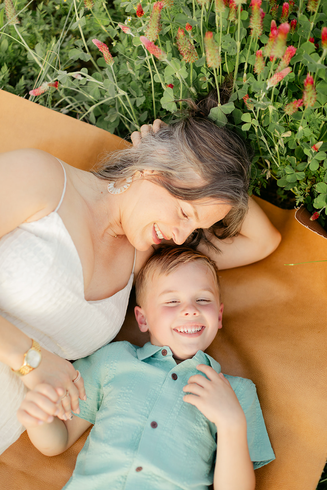 smiling mama and son. Outdoor photo session in green field.